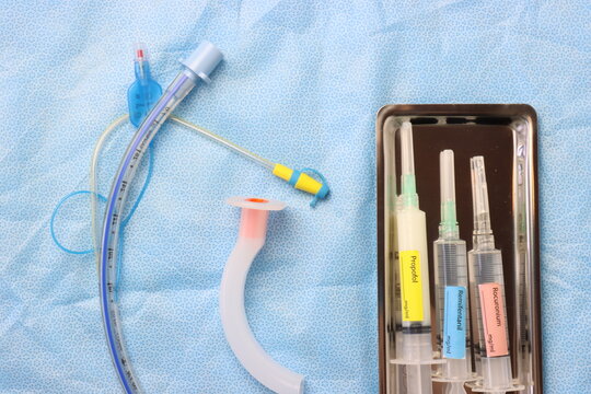Surgical surface top view of a endotracheal tube, Oropharyngeal airway and tray with anesthetic syringes