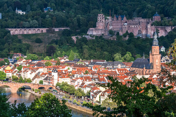 Fototapeta premium View of German city Heidelberg with castle, and Church of the Holy Spirit (German: Heiliggeistkirche) and old city on a sunny summer evening