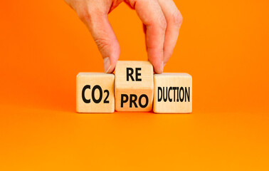 CO2 production or reduction symbol. Concept word CO2 production reduction on a wooden block on a...