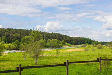 Beautiful peaceful countryside landscape view on pale blue sky background. Sweden.