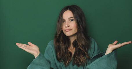 Happy woman, hands and advertising in decision on green studio background. Female showing palm for advertisement, choice or selection to choose on mockup space. Woman take decision, shrugging shoulder