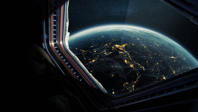 Spaceship flies near the amazing night planet earth, view from the window. Travel and tourists in space, concept. Beautiful space view of the Earth with night city lights. Hotel in space