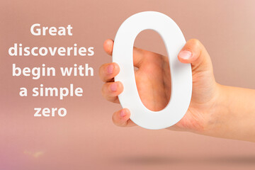 Great discoveries start from a simple zero. Close-up concept photo of a hand holding a white zero...