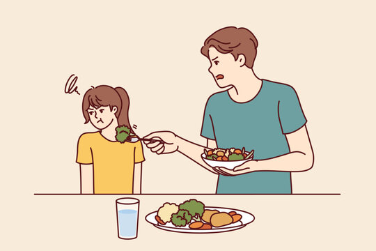 Child does not want to eat salad and green vegetables standing near father trying to teach daughter eat healthy food. Stubborn teenage girl refuses healthy vegetables and turns away.