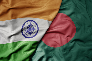 big waving realistic national colorful flag of india and national flag of bangladesh .