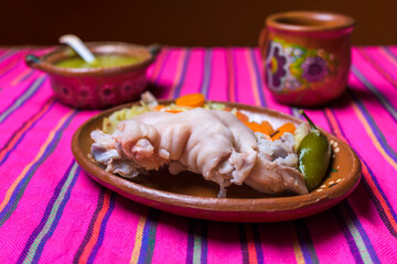 Fresh pig trotters on a colorful background traditional mexican food