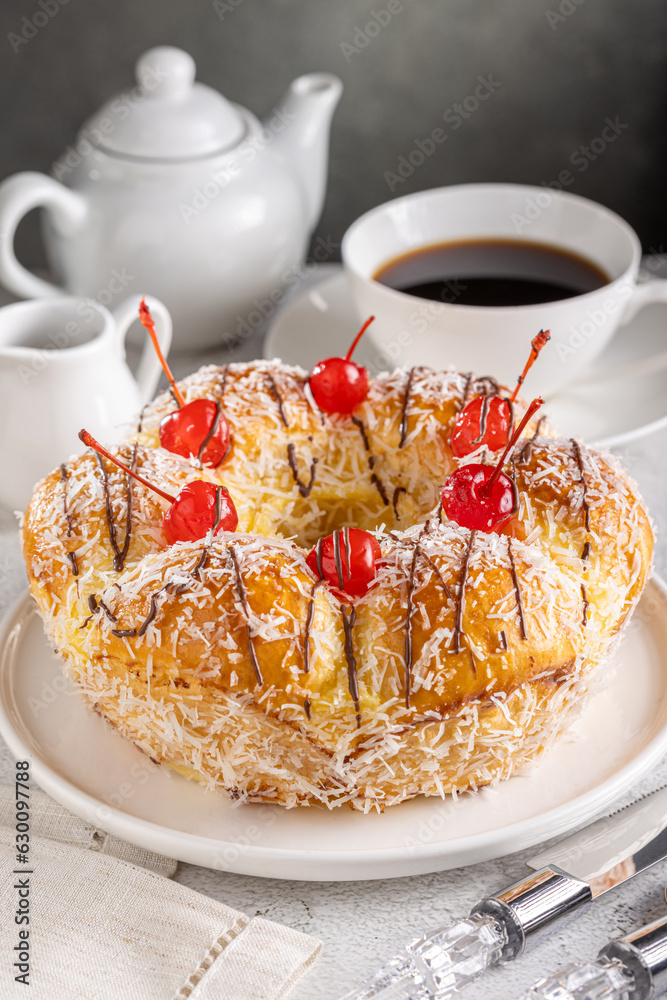 Wall mural Sweet bread with pastry cream, coconut and cherry.