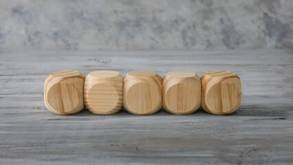 Business  design concept.  Five abstract geometric wooden blank dice isolate on white rustic surface.