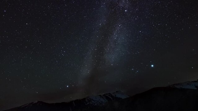 Majestic View Of Night Sky Over Mountain Range Filmed From Below In Timelapse. Scenery Of Shining Stars Moving And Rotating Above Cliffs. Cosmos And Astronomy. Enjoying Milky Way View. Universe Theme.