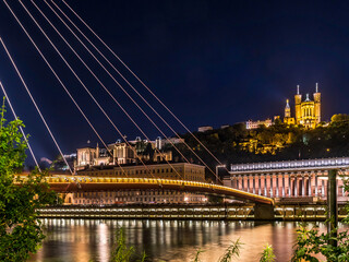 View of footbrige over Saone river and Vieux Lyon by night in Lyon, France