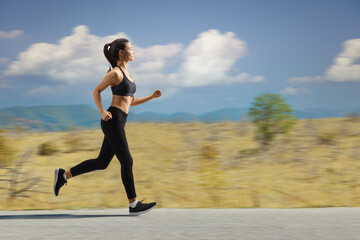 Young female jogging on a road