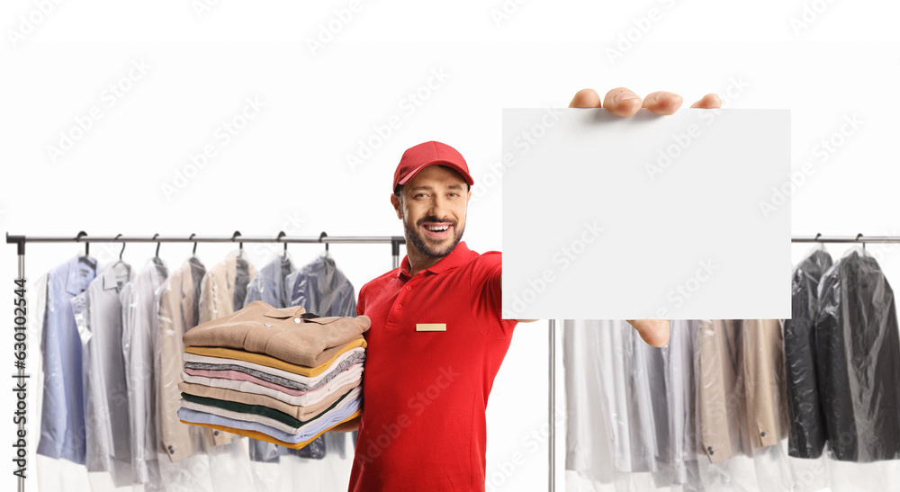 Poster Laundry worker holding a pile of clothes and showing a blank card at the dry cleaners