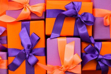 Different gift boxes with ribbons for Halloween as background, closeup