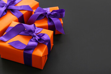 Beautiful gift boxes for Halloween on dark background, closeup