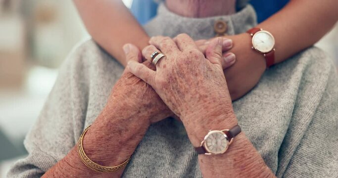 Nurse, holding hands and senior patient hug with caregiver and support in retirement home with empathy. Elderly person, healthcare professional and doctor with kindness, helping and hope in a clinic