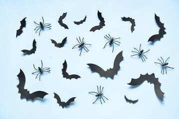 Paper bats and spiders for Halloween party on blue background