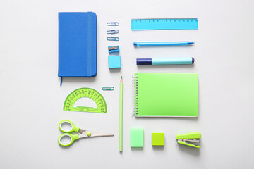 Different school stationery and notebooks on grey background