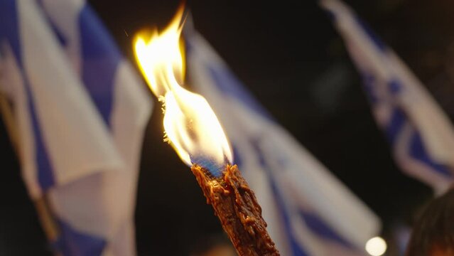 Protesters in Israel march with tourches during protest against judicial reform