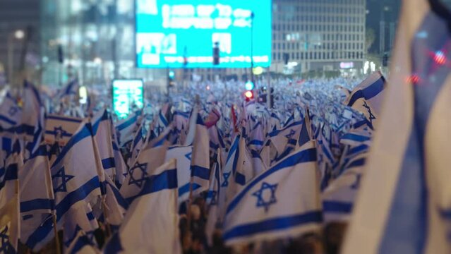 Thousands of people wave Israeli flags during demonstrations