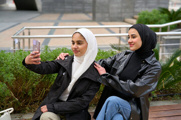 Young muslim women with hijabs taking selfie