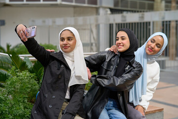 Young muslim women with hijabs taking selfie