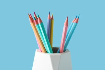 Fototapeta premium Holder with different pencils on color background, closeup