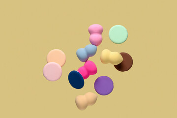 Flying different makeup sponges on yellow background