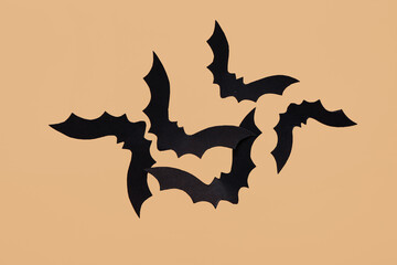 Paper bats for Halloween party on beige background