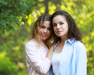 Obraz premium Close up of mother and grandmother smilling in a park