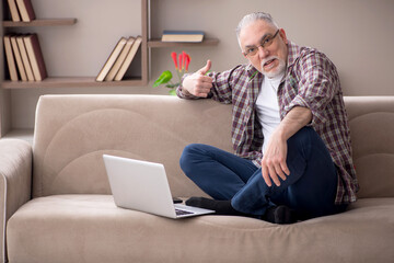 Old man working from home during pandemic