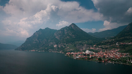 Mountain panorama at Lake Iseo with mountains and village Marone from above during day with blue...