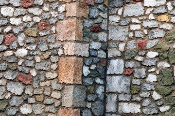 colorful and solid stone worked house walls in close up