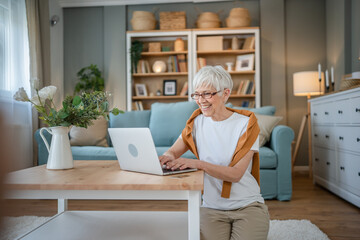 Senior caucasian woman use laptop computer at home for work