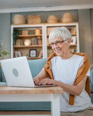 Senior caucasian woman use laptop computer at home for work