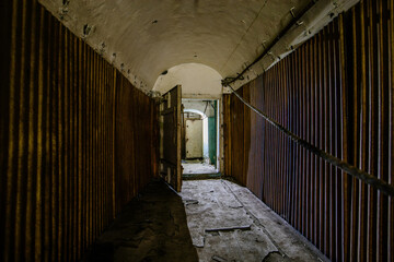 Old vaulted corridor of Soviet bunker, echo of Cold War