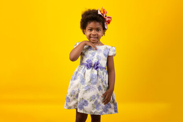 Brazilian black child with curly hair, in studio shot with various facial expressions