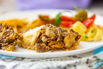 Traditional homemade mayonnaise salad with roasted chicken stuffed with Brazil-style farofa