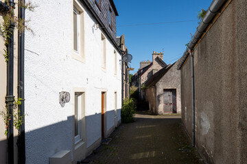 Fototapeta na wymiar 1 August 2023. Nairn,Scotland. This is partly shaded lane leading to some houses from High Street on a sunny summer day