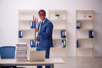 Devil businessman and too much work in the office
