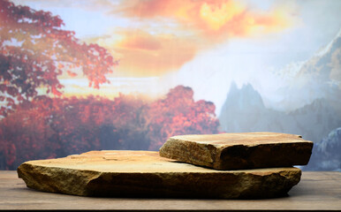 autumn podium with brown and zen stones against autumn nature and sky for background product...