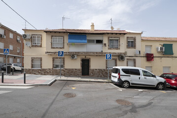 Facades of two-story buildings with parking for disabled