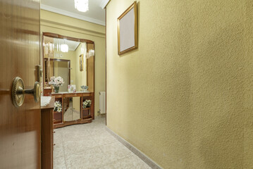 Entrance hall of a residential house with walls painted yellow with gotelet