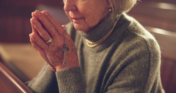 Hands, praying and senior woman in church for christian connection, spiritual or faith. Gratitude, belief and elderly person in retirement, religion or praise to God in worship chapel for hope