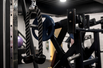 Closeup of a tricep rope attachment at a gym or fitness club. Workout and training concept.