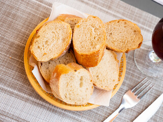 Bread sliced and served on table in wicker plate