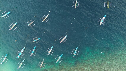 Aerial view of rows of fishing boats in the sea
