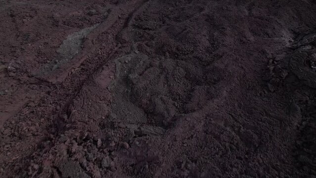 DRONE AERIAL FOOTAGE: View of cracked lava crust or ingenious rock and steam cooled down from the 2021 eruption of Fagradalsfjall volcano in Geldingadalir Valley on Reykjanes Peninsula in Iceland.