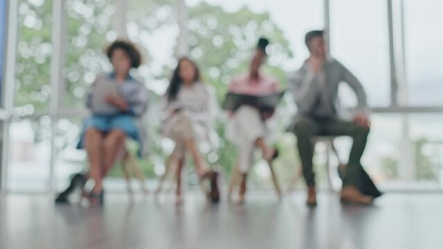 Business people, row and sitting in waiting room for hiring, recruiting or opportunity against a blurred background. Group of employees in relax for job or career meeting in line together at office