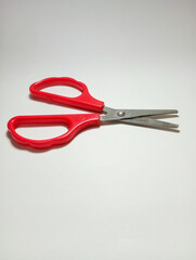 A Pair of Red Scissors on White Background