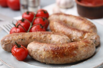 Plate with tasty homemade sausages and tomatoes, closeup